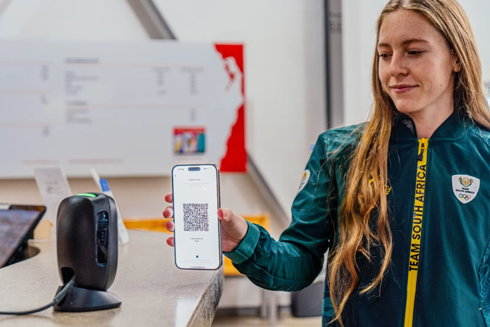 Member scanning a QR access pass at the gym entrance